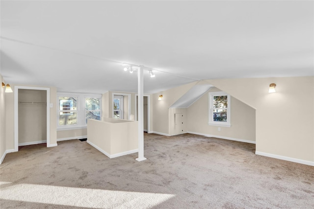 bonus room featuring carpet flooring and vaulted ceiling