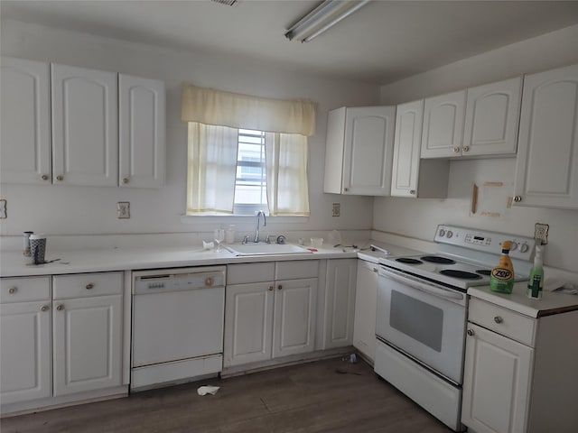 kitchen with white cabinetry, white appliances, and sink