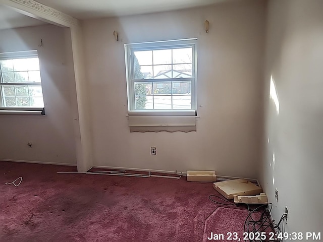 carpeted empty room with a wealth of natural light