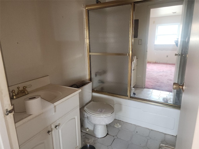 full bathroom featuring toilet, vanity, and bath / shower combo with glass door