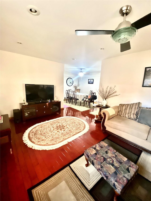 living room featuring hardwood / wood-style flooring and ceiling fan