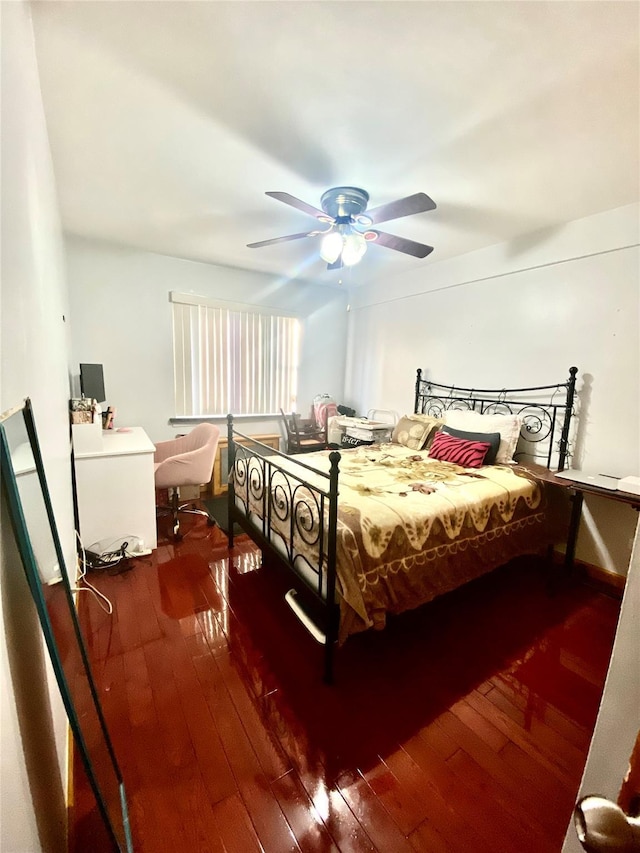 bedroom with dark hardwood / wood-style floors and ceiling fan