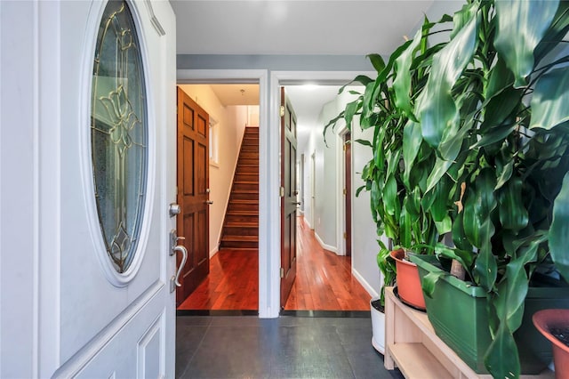 foyer featuring dark tile patterned flooring