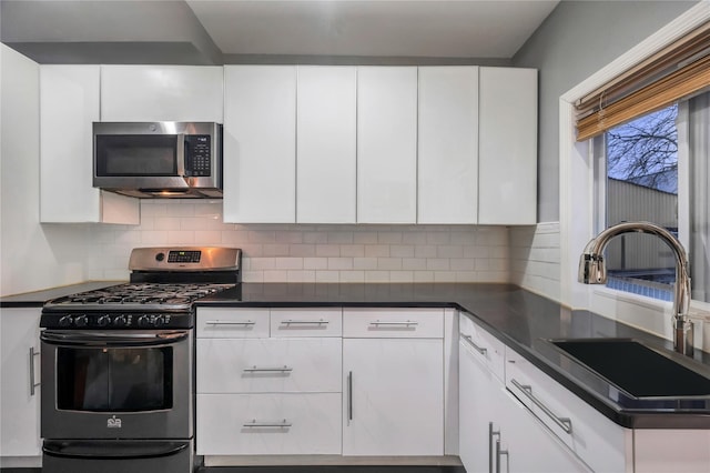 kitchen featuring white cabinetry, sink, tasteful backsplash, and appliances with stainless steel finishes