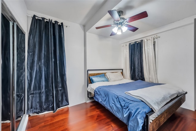 bedroom with dark wood-type flooring and ceiling fan