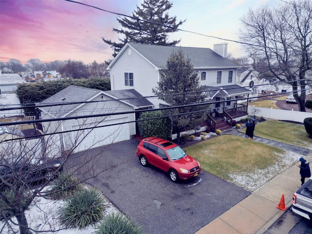 view of front facade with a garage and a yard