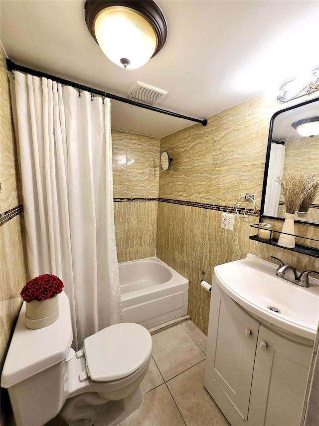 full bathroom with tile walls, shower / tub combo, tile patterned flooring, vanity, and toilet