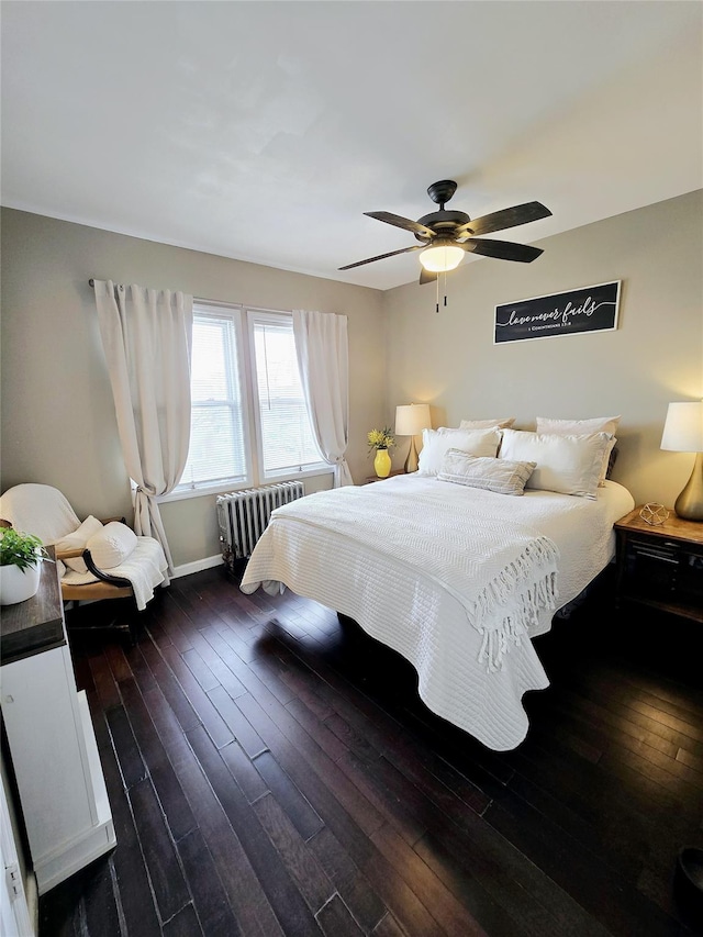 bedroom featuring ceiling fan, radiator heating unit, and dark hardwood / wood-style floors