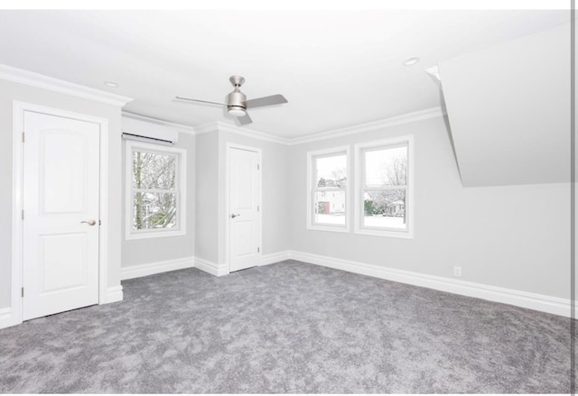 unfurnished bedroom with ceiling fan, a wall mounted AC, and carpet