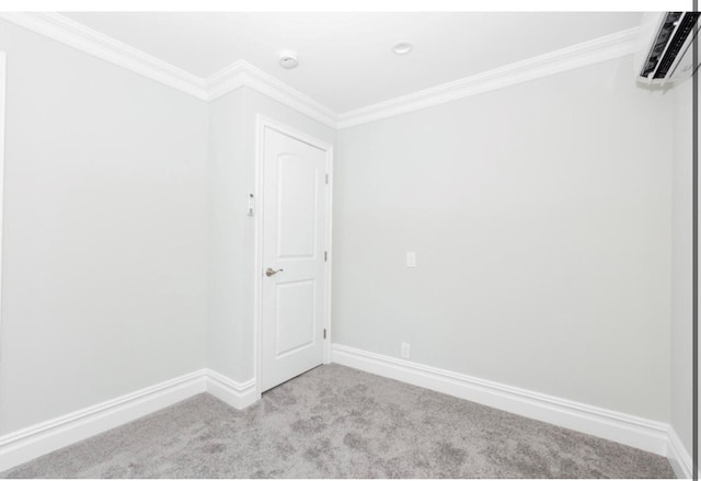 spare room featuring light colored carpet and ornamental molding