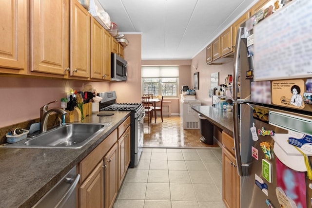 kitchen featuring appliances with stainless steel finishes, sink, and light tile patterned floors