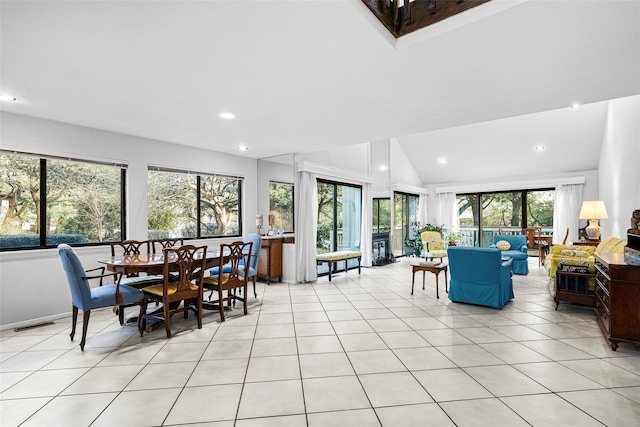 dining room featuring light tile patterned floors, lofted ceiling, and recessed lighting