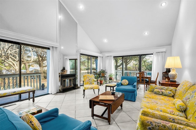 living room featuring high vaulted ceiling, a wealth of natural light, and light tile patterned flooring