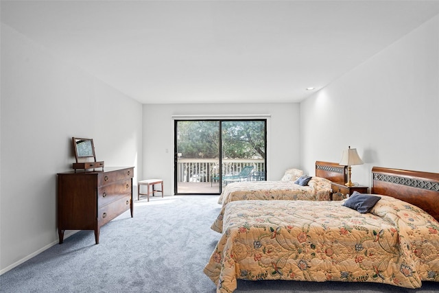 carpeted bedroom featuring access to outside and baseboards