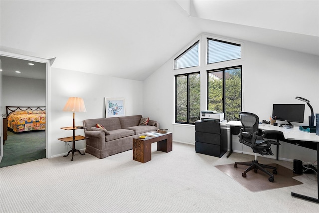 carpeted home office with lofted ceiling and baseboards