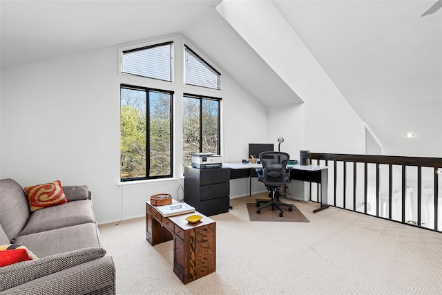 office area featuring baseboards, vaulted ceiling, and light colored carpet