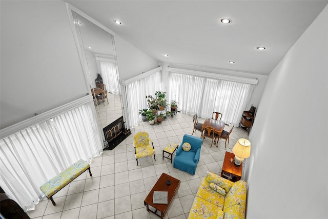 living area with light tile patterned flooring, a tile fireplace, and recessed lighting