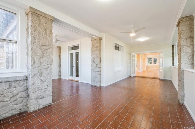 unfurnished room with ceiling fan, ornamental molding, and a wealth of natural light