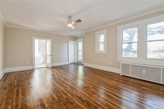 empty room featuring dark wood-type flooring, ceiling fan, ornamental molding, and radiator