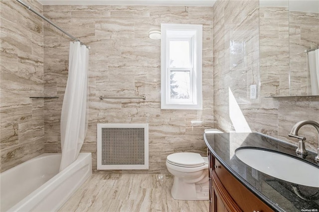 full bathroom with vanity, shower / bath combo, tile walls, and toilet