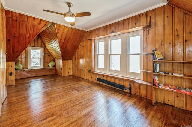 bonus room featuring ceiling fan, wood-type flooring, vaulted ceiling, and wood walls