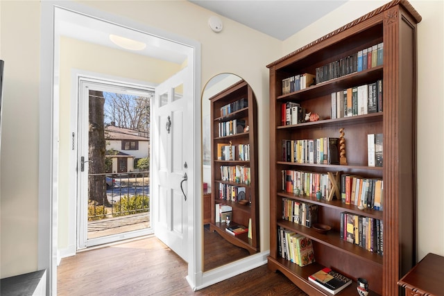 interior space with baseboards, a healthy amount of sunlight, and wood finished floors