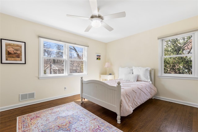 bedroom with a ceiling fan, baseboards, visible vents, and dark wood-style flooring