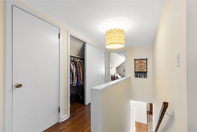 hallway with an upstairs landing and dark wood-style floors