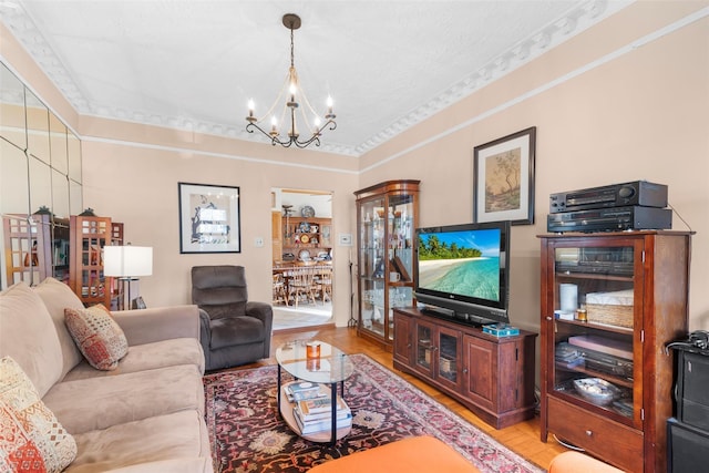 living room with an inviting chandelier and light hardwood / wood-style flooring