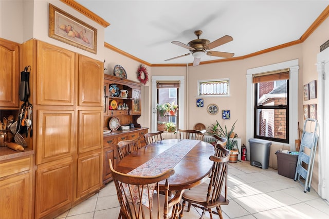 tiled dining room with crown molding, a wealth of natural light, and ceiling fan