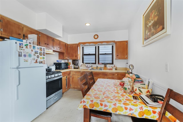 kitchen with white refrigerator and gas range