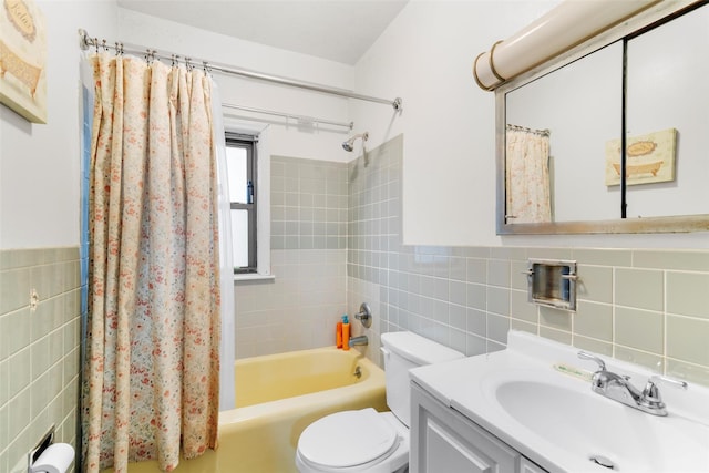 full bathroom with tile walls, vanity, toilet, and shower / tub combo with curtain