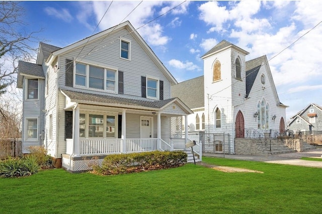 view of front of house featuring a front yard and covered porch