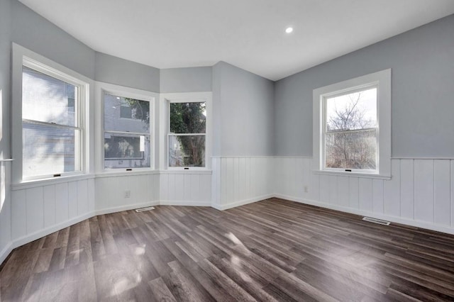 spare room with dark wood-type flooring