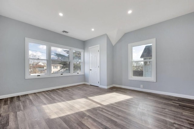 empty room with wood-type flooring and a wealth of natural light