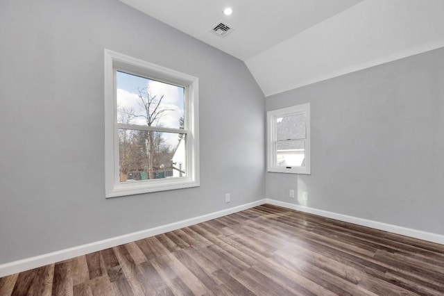 additional living space featuring hardwood / wood-style floors and vaulted ceiling