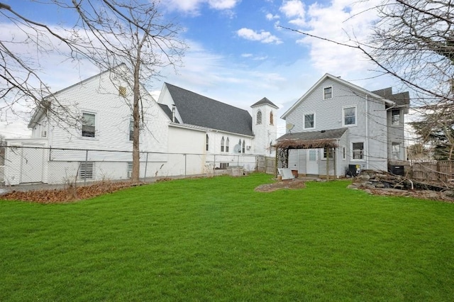 back of property featuring a gazebo and a lawn