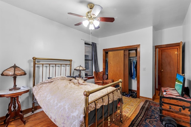 bedroom featuring ceiling fan, light hardwood / wood-style floors, and a closet