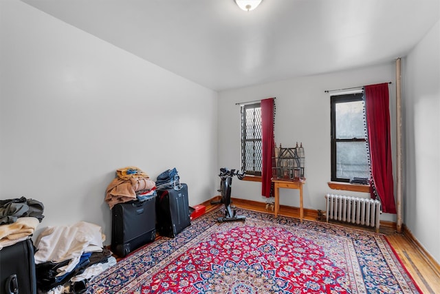 misc room featuring hardwood / wood-style floors and radiator heating unit