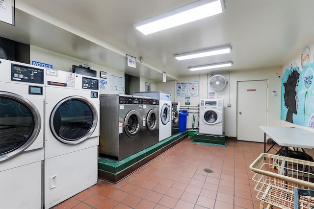 laundry room featuring tile patterned floors and washing machine and dryer