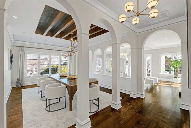 interior space with a chandelier, plenty of natural light, and wood finished floors