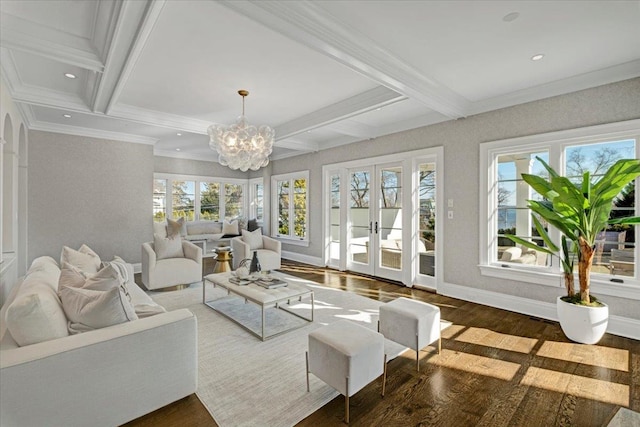 sunroom / solarium with a wealth of natural light, a notable chandelier, beam ceiling, and french doors