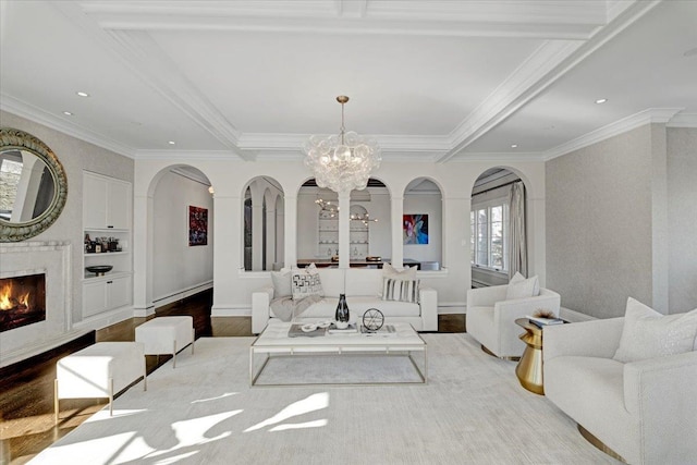 living room with arched walkways, a fireplace, wood finished floors, a chandelier, and beamed ceiling