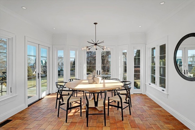 sunroom / solarium featuring a chandelier, french doors, and visible vents