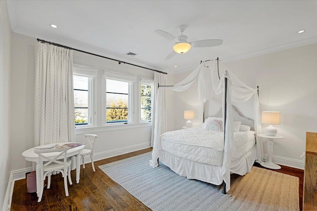 bedroom featuring baseboards, crown molding, visible vents, and wood finished floors