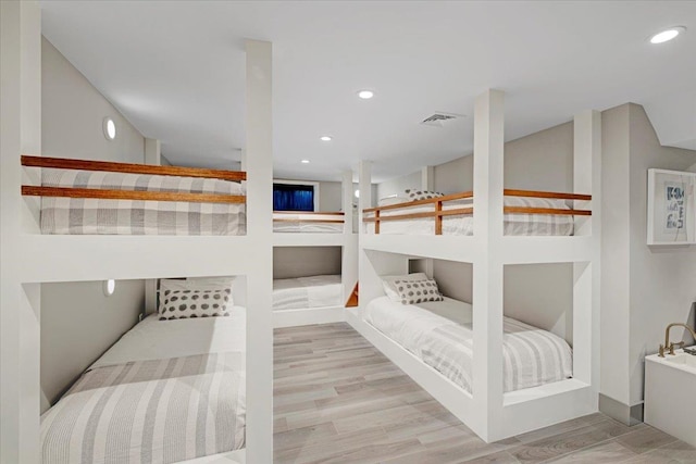 bedroom featuring recessed lighting, visible vents, and wood finished floors