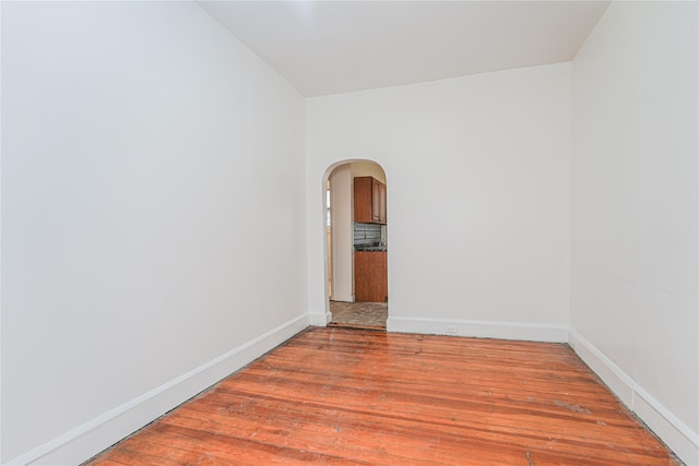 empty room with hardwood / wood-style flooring