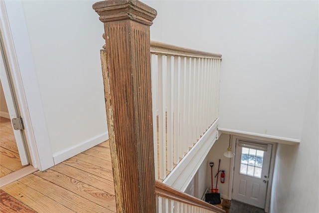 stairs featuring hardwood / wood-style floors