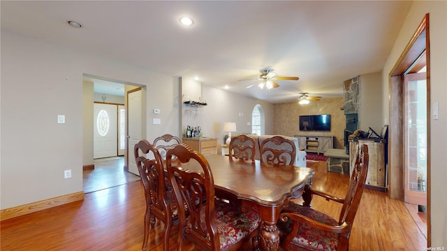 dining area with ceiling fan and light wood-type flooring