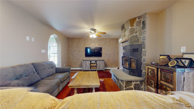 living room featuring a baseboard heating unit, hardwood / wood-style floors, and ceiling fan